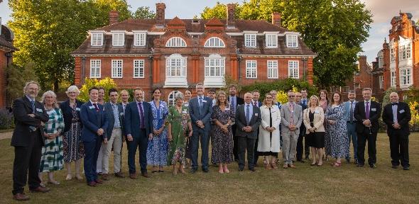 Prize winners standing in front of Newnham College Picture of prize winners