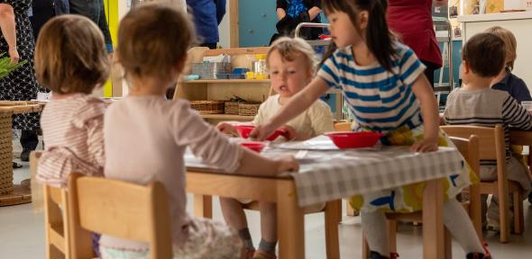 Children sat at a table Children at the Chris Abell Nursery opening
