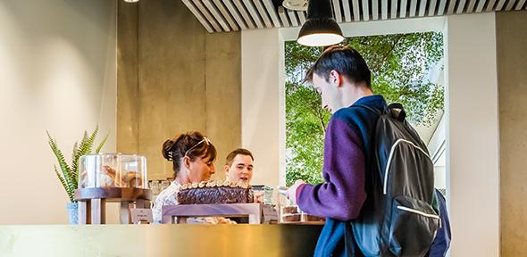 Customers at cafe counter West hub Cafe