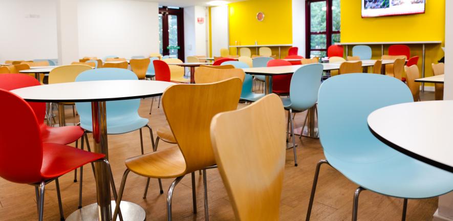 bright coloured chairs and white tables