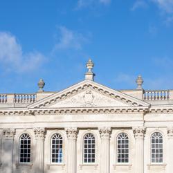The image shows the upper part of the Senate House against a blue sky.