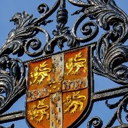 University crest against a blue sky