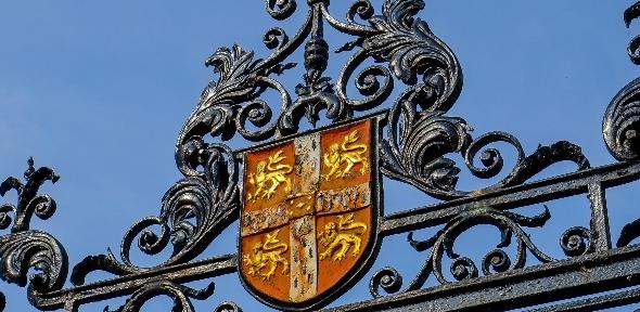 University crest against a blue sky